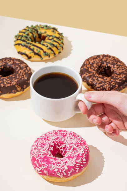 istock Espresso coffee cup and fresh donuts on yellow background with shadow. 2192049411