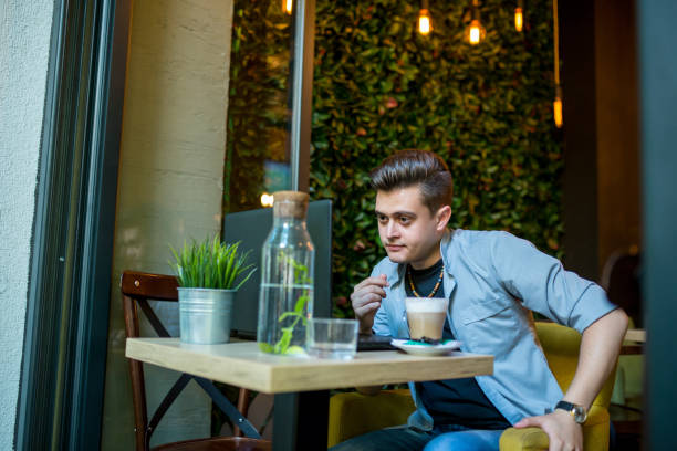 istock Young man with laptop and coffee working indoors 2192049720