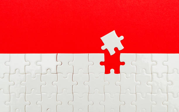 istock White jigsaw puzzle pieces on red background with copy space 2192049728