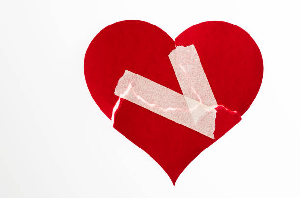istock Broken heart with adhesive tape on white background 2192049940