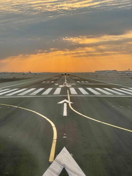 istock Airport runway with orange sky 2192053743