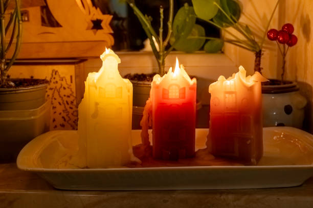 istock Candles in different colors illuminate a cozy indoor space with plants during evening hours 2192055017