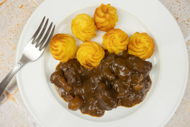 istock beef bourguignon and duchesse potatoes, close-up, on a plate 2192055825