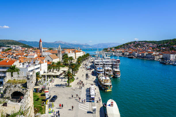 Trogir, Croatia - September 21, 2024: Scenic Trogir old town view from Kamerlengo Fortress, moored big-sized luxury motor yachts at promenade pier