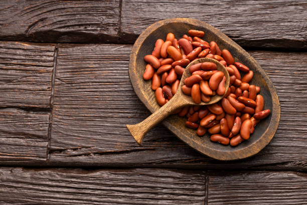 istock Phaseolus vulgaris - Raw dried beans in bowl and spoon. 2192060221