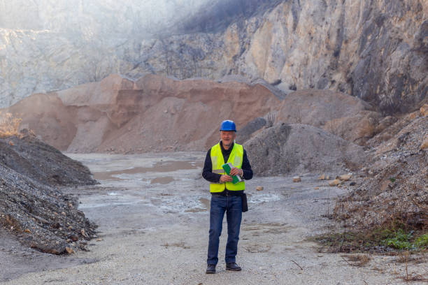 istock Worker with protective helmet and reflective west at gravel surface mine 2192064991
