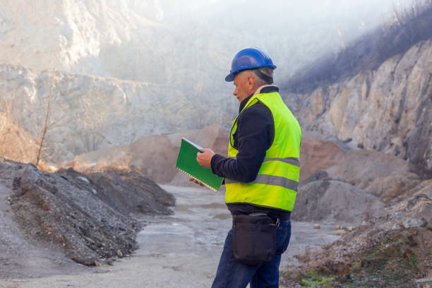 istock Worker with protective helmet and reflective west at gravel surface mine 2192064997