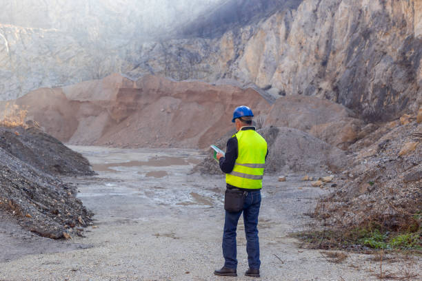 istock Worker with protective helmet and reflective west at gravel surface mine 2192064998