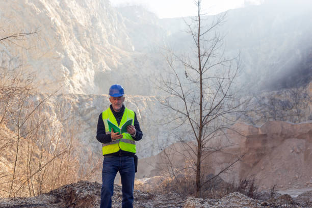 istock Worker with protective helmet and reflective west at gravel surface mine 2192065003