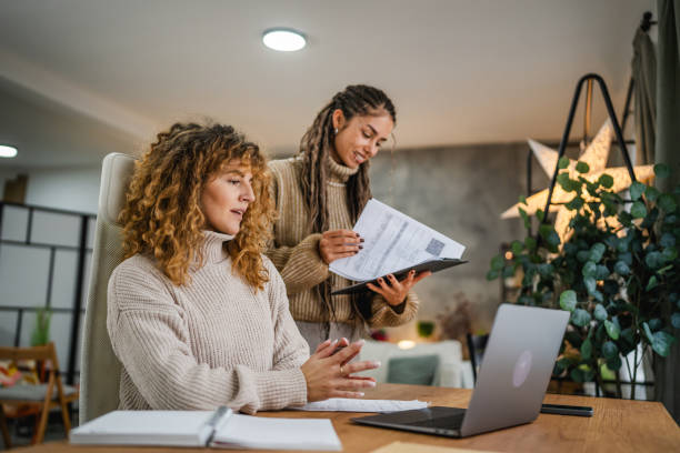 istock two female colleagues work on laptop real teamwork at home office 2192065207