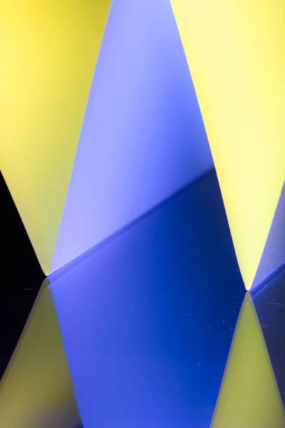 Sharp angles and vivid hues in different blue and yellow tints with black combine to form a captivating abstract composition, showcasing the beauty of geometry in art. The striking contrasts draw viewers into the vibrant interplay of colors.