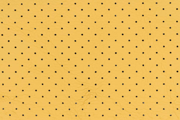 istock Yellow color abstract artificial leather with small dots and holes pattern for background 2192068620