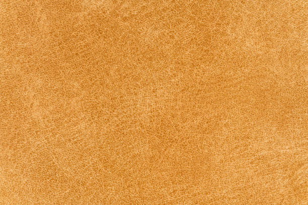 Yellow color abstract textile pattern for background. Close-up detail photography table top view of fawn colour surface level fabric material, background texture of cloth for design element