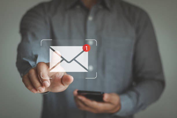 istock Email marketing notification concept. Business man use smartphone to interact with a digital interface showing a new electronic mail notification icon, a concept for online technology communication. 2192069153