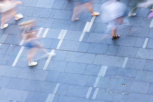 istock Elevated view of blurred walking people in city, abstract background with copy space 2192069944