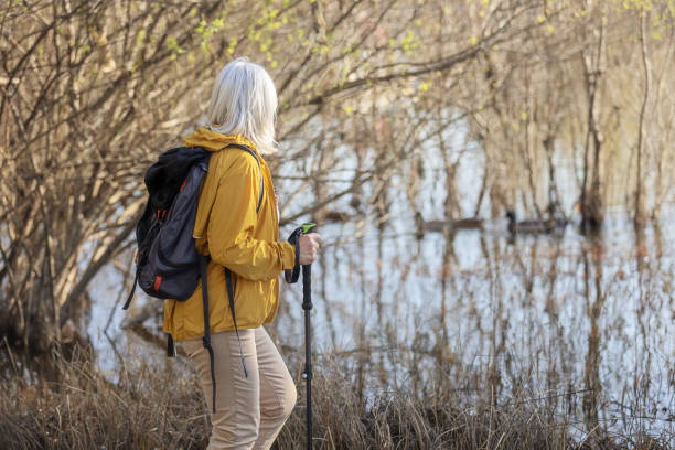 istock Exploring Nature: Woman Hiking By A Serene Lake with Backpack 2192070186