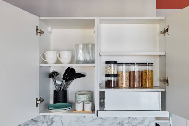 istock A beautifully organized kitchen cabinet, filled with cookware, ingredients, and more items 2192070953
