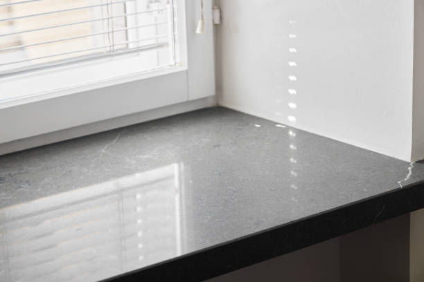 The stylish black stone window sill is enhancing the natural light pouring into this contemporary living space