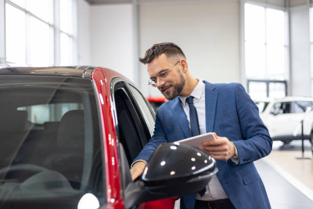 istock Professional inspecting a car in showroom 2192076356
