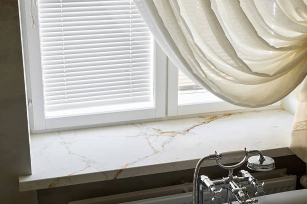 An Elegant Marble Window Sill Graced with a Beautifully Draped Curtain Enhancing Style