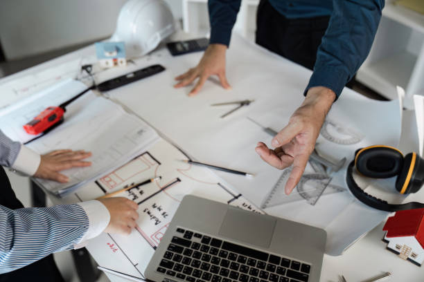 istock Engineers and architects collaborate on blueprint designs in modern office environment with innovative ideas 2192087769