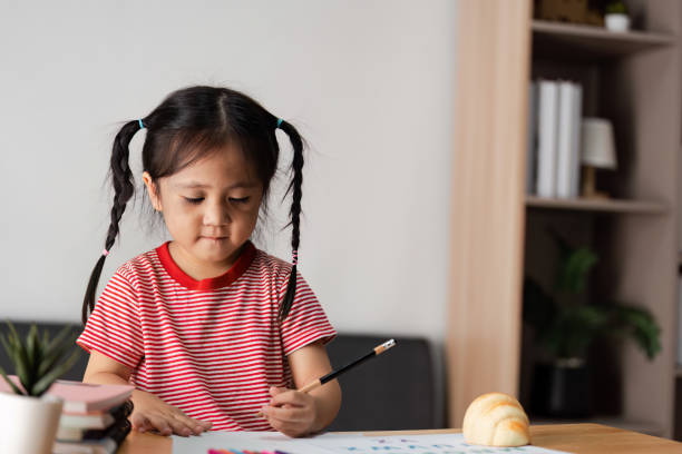 istock Parent and Child Engaged in Learning Activity at Home, Fostering Education and Bonding Through Creative Play and Study 2192088254