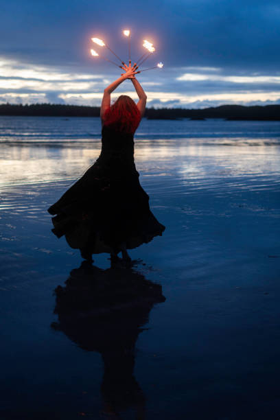 Fire dancer on MacKenzie Beach, Tofino, Vancouver Island, British Columbia, Canada