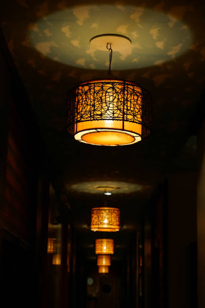istock Warmly lit corridor with decorative pendant lights 2192093756