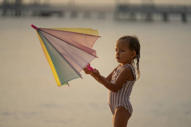 Happy little girl at summer beach Sunset. Smiling in summer vacation.
