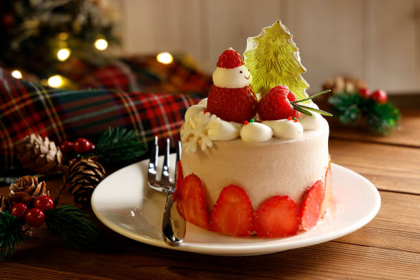 istock A Small Christmas Cake Decorated with Snowman with Plate and Fork on Wooden Table 2192096839