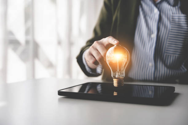 istock Hand holding a fluorescent light bulb Create new ideas, innovation, brainstorming and inspiration. strategic planning concepts and technology business ideas 2192100786