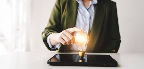 istock Hand holding a fluorescent light bulb Create new ideas, innovation, brainstorming and inspiration. strategic planning concepts and technology business ideas 2192100794