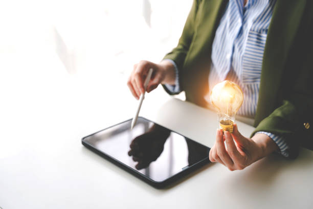 istock Hand holding a fluorescent light bulb Create new ideas, innovation, brainstorming and inspiration. strategic planning concepts and technology business ideas 2192100809