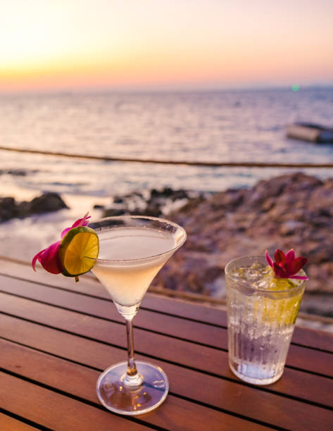 Enjoying tropical cocktails at sunset on Koh Munnork Island in Rayong, Thailand