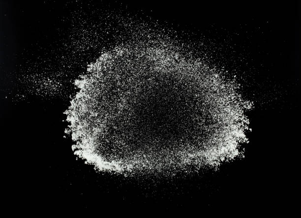 istock Fluffy White snow splash flying or throwing in mid air. Snowfall on Black background isolated. Snow dust element falling over dark night 2192101545