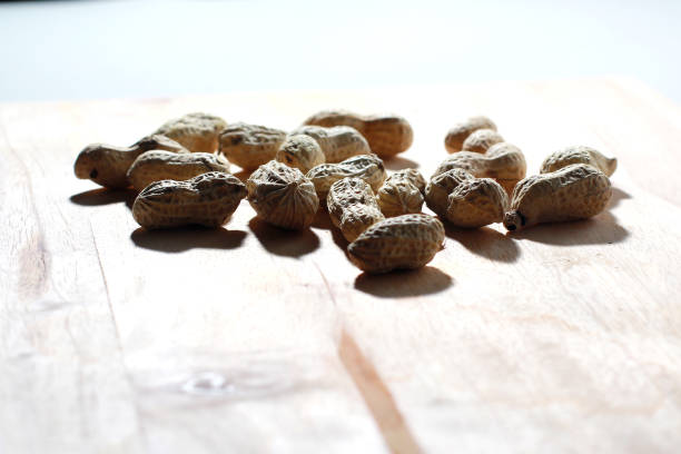roasted peanuts on a wooden table, good for article or commercial