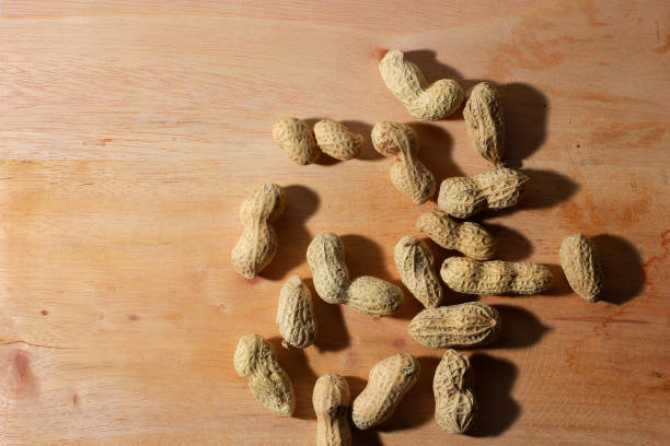 roasted peanuts on a wooden table, good for article or commercial