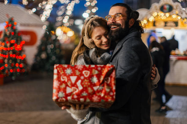 istock Lovely couple sharing gifts for holiday 2192105089