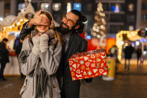 istock Lovely couple sharing gifts for holiday 2192105090