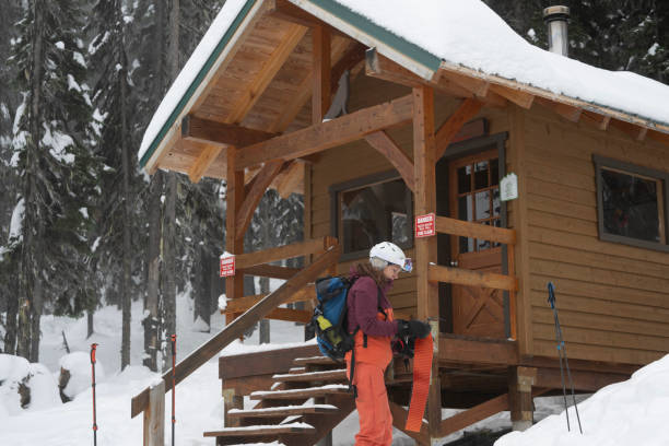 istock Backcountry skier prepares skis in front of cabin 2192105950