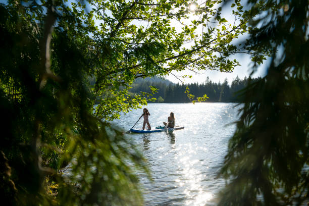 istock Mother and daughter enjoy SUP board on mountain lake 2192106926