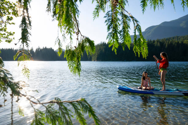 istock Mother and daughter enjoy SUP board on mountain lake 2192107058