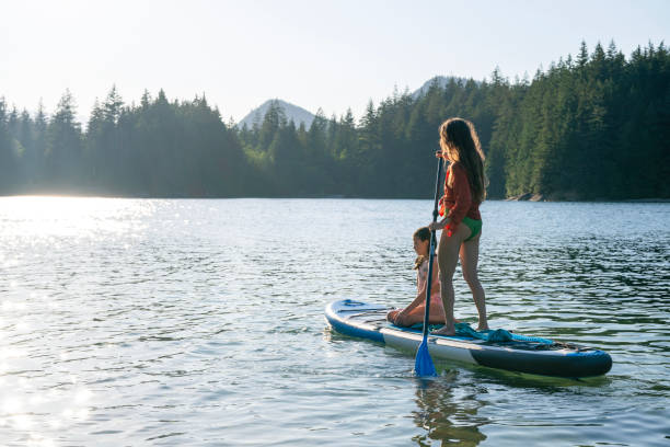 istock Mother and daughter enjoy SUP board on mountain lake 2192107059