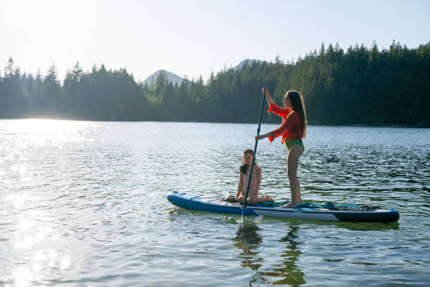 istock Mother and daughter enjoy SUP board on mountain lake 2192107065