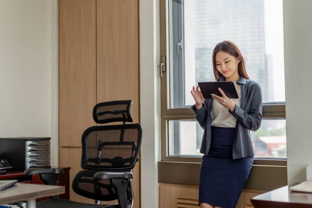 istock Professional business woman using digital tablet in office 2192107763