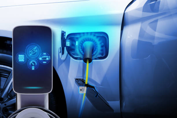 istock Power cable pump plug in charging power to electric vehicle EV car. 2192109205