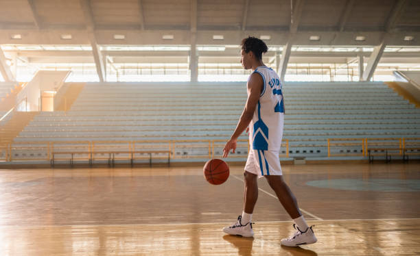istock Basketball player dribbling ball at court 2192109328