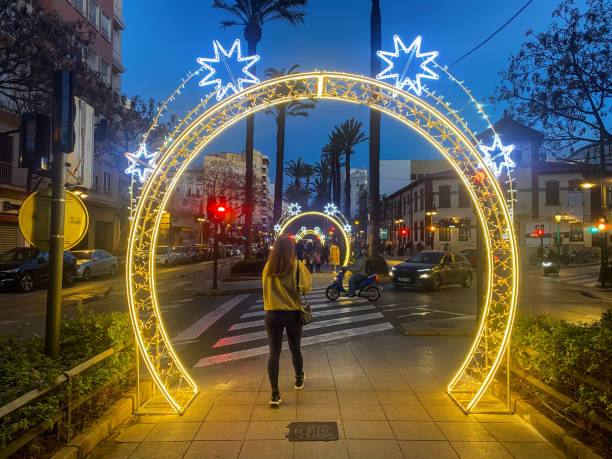 Valencia, Spain - December 19, 2024: Arched light ornaments installed in the boulevard of the Reino de Valencia avenue. During the Christmas season the whole downtown area of the city and its surroundings is decorated with all sorts of light designs according to the celebration mood that there is in the city