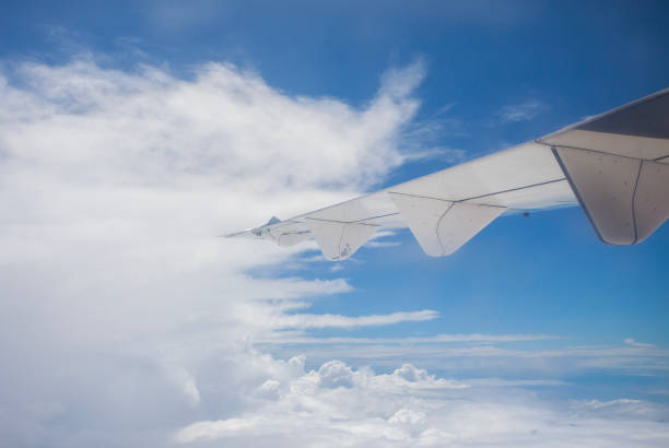 Beautiful, dramatic a group of clouds in the sky, viewed from a height from inside an airplane.