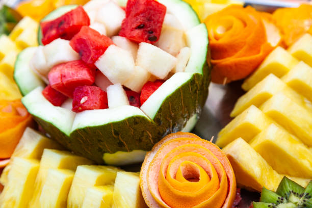 Decorative fruit salad on a fruity background. Sliced watermelon, melon, pineapple and grapefruit.